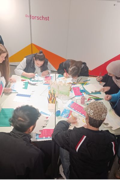 Schülergruppe sitzend um Tisch